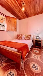 a bedroom with a large bed with a wooden ceiling at Hotel Hacienda Inglaterra in Sevilla