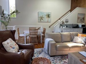 a living room with a couch and a table at Beach Vibes Accommodation in Scotts Head