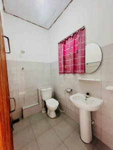 a bathroom with a toilet and a sink at Viyan hotel in Negombo