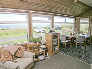 a living room with a couch and a table at Braemar in Lendalfoot