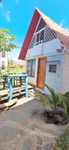 a house with a blue table in front of it at Cabañas Don Jorge - Cabaña Fragata in Puerto Baquerizo Moreno
