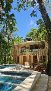 a house with a swimming pool in front of a house at Toro by Dreamcatcher in Santa Teresa Beach
