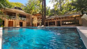 a swimming pool in front of a house at Toro by Dreamcatcher in Santa Teresa Beach