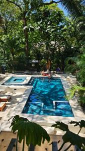 a swimming pool with a person in the middle at Toro by Dreamcatcher in Santa Teresa Beach