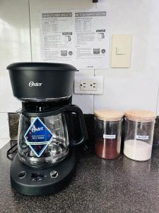 a blender sitting on top of a counter with two jars at León Dormido Suite 01 in Puerto Baquerizo Moreno +14 photos