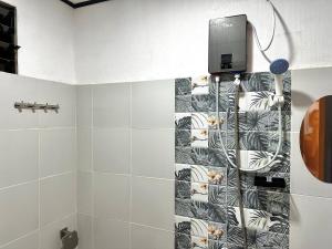 a bathroom with a shower with a wall at Casa Mia in El Nido +27 photos