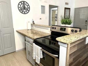 a kitchen with a stove and a counter top at 1BD condo DFW South I10 in Sowers