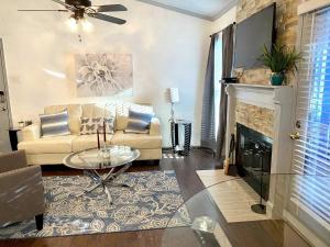 a living room with a couch and a fireplace at 1BD condo DFW South I10 in Sowers