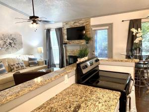 a kitchen and living room with a stove at 1BD condo DFW South I10 in Sowers
