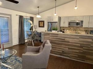 a kitchen with white cabinets and a table and chairs at 1BD condo DFW South I10 in Sowers