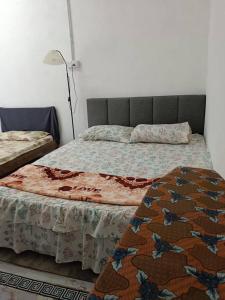 Postel nebo postele na pokoji v ubytování Roomstay Ummi
