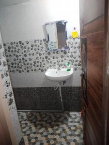 a bathroom with a sink and a mirror at Manvitha Homestay in New Hampi