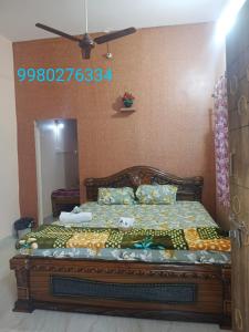 a bedroom with a bed in a room with a mirror at Manvitha Homestay in New Hampi +2 photos