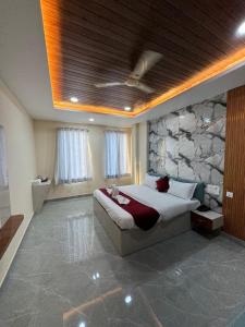 a bedroom with a bed and a stone wall at The Vizata Hotel in Jaipur