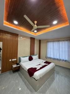 a bedroom with a bed with a ceiling fan at The Vizata Hotel in Jaipur
