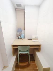 a desk in a room with a blue chair at Joy Hella Inn in Hong Kong