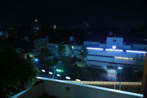 a building with blue lights on top of it at night at The Crownstone Apartment in Trivandrum