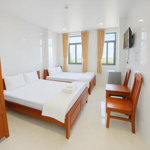 Postel nebo postele na pokoji v ubytování Bảo Di Sóc Trăng Hotel + 26 fotografií