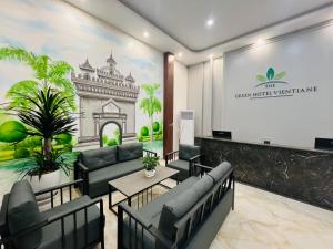 a waiting room with couches and a wall with a mural at The Green Hotel Vientiane in Vientiane +27 photos