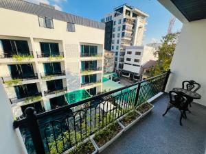 a balcony with a bench and a building at The Green Hotel Vientiane in Vientiane