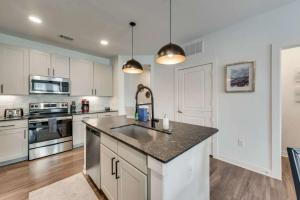 a kitchen with white cabinets and a counter top at Luxury 3BD Apt Smart Home Pool Grapevine GV202 in Minters Chapel