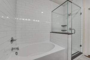a white bathroom with a tub and a glass shower at Luxury 3BD Apt Smart Home Pool Grapevine GV202 in Minters Chapel +8 photos