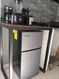 a refrigerator under a table in a kitchen at Alojamiento de La Luna in Mexico City
