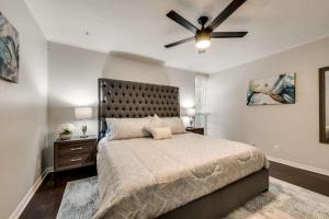 a bedroom with a large bed with a ceiling fan at Stylish 2BD Condo Pool Grand Prairie GP66B in Heliport-Facility 5A