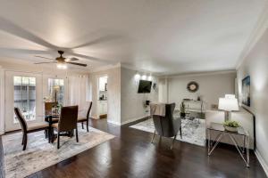 a dining room and living room with a table and chairs at Stylish 2BD Condo Pool Grand Prairie GP66B in Heliport-Facility 5A