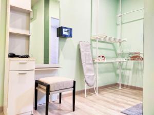 a chair and a mirror in a room at Palm Garden house 1 close to Bang Tao beach in Ban Phak Chit