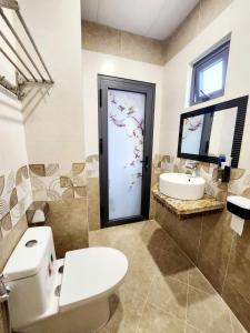 a bathroom with a toilet and a sink at HA Hotel & Apartment in Vung Tau