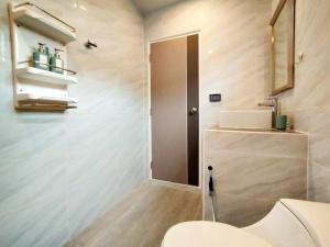 a bathroom with a toilet and a sink at Palm Garden house 1 close to Bang Tao beach in Ban Phak Chit +17 photos