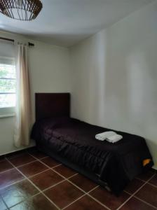 a bedroom with a bed in the corner of a room at Cabañas El Ceibo in La Bolsa