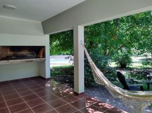 a hammock in a room with a view of a yard at Cabañas El Ceibo in La Bolsa