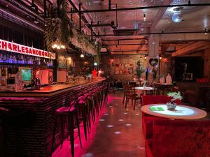 a bar with tables and chairs in a restaurant at Hotel Stay Interview Jeju in Seogwipo