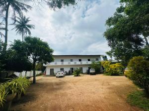 a building with two cars parked in front of it at Viyan hotel in Negombo +11 photos
