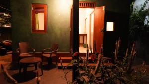 a room with chairs and a table and a door at New Morning Hikkaduwa in Hikkaduwa