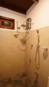 a bathroom with a shower with a shower head at New Morning Hikkaduwa in Hikkaduwa