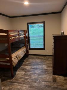 a room with two bunk beds and a window at Panther Creek retreat in Clarkesville