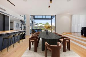a kitchen and living room with a table and chairs at Ebony Escape in Casuarina