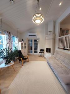 a living room with a couch and a rug at House between pines 5-bedroom house with 3 toilets in Rovaniemi