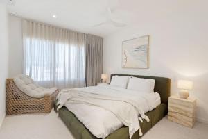 a bedroom with a large bed and a window at Ebony Escape in Casuarina +19 photos