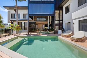 an exterior view of a house with a swimming pool at Ebony Escape in Casuarina