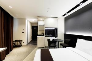 Ένα ή περισσότερα κρεβάτια σε δωμάτιο στο GloucesterHotel Kintex