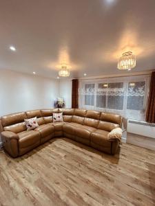 ein Wohnzimmer mit einem braunen Ledersofa in der Unterkunft Luxury apartment in Guildford in Guildford