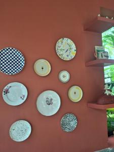 a wall with plates hanging on a wall at The Vicarage in Mirissa