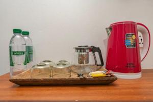a counter with a coffee maker and jars on a table at Punleu Raksmey Hotel in Siem Reap