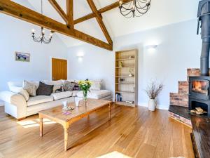 a living room with a couch and a table at Low Barn in Market Bosworth