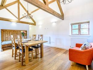 a dining room with a wooden table and chairs at Low Barn in Market Bosworth