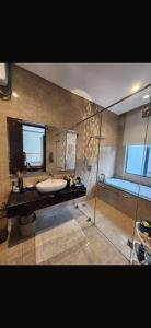 a bathroom with a tub and a sink and a shower at sea l in Jakarta